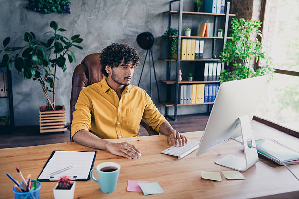 istock Photo of confident successful man sitting working codding program online modern office room 2215972079
