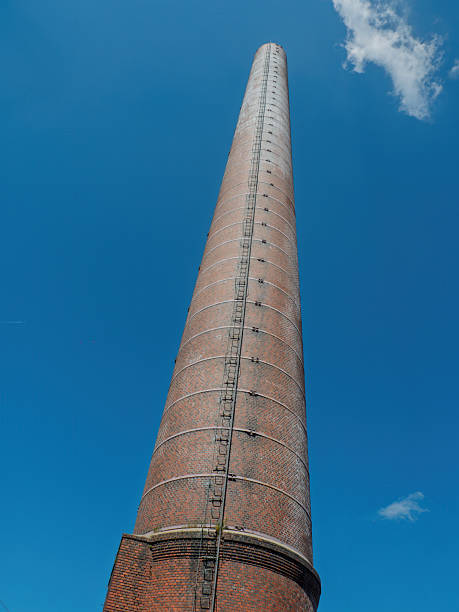 istock Industrial Brick Chimney Tower Against Clear Blue Sky 2215972095