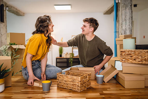 istock Happy couple having fun while unpack boxes together and drink coffee 2215972157