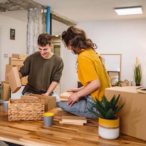 istock Happy couple having fun while unpack boxes together and drink coffee 2215973745