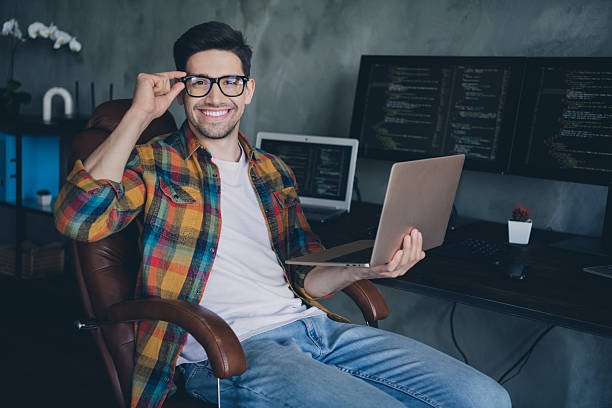 istock Photo of positive intelligent pc operator guy sitting chair use wireless laptop server optimization business center inside 2215975121