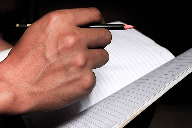 Close up hand with a Pencil on white background design.