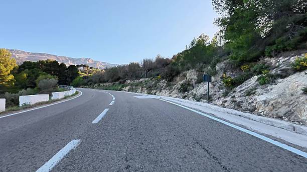 istock A Scenic Winding Road That Curves Through Lush Greenery and Beautiful Rolling Hills 2215978700