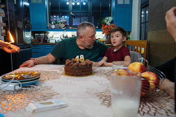 Portrait of father and son on gathering for father's birthday in cozy modern home. Sharing warm moments of love and making memories together.