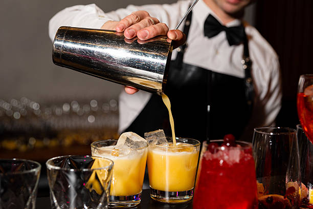 istock Bartender Pouring Fresh Citrus Cocktail at Bar. 2215984549