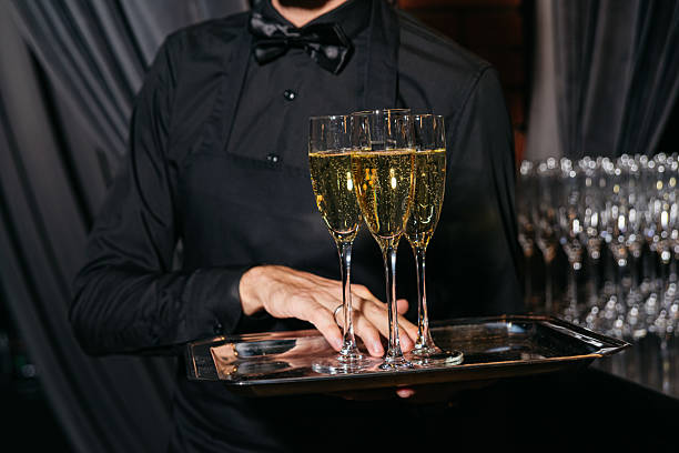 istock Waiter serving champagne flutes at formal event. 2215984635