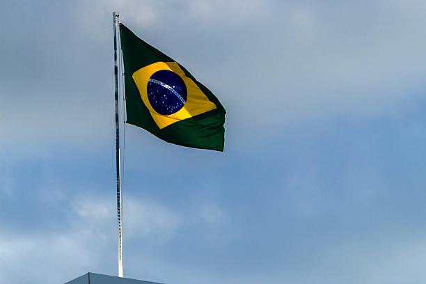 istock Brazilian flag waving against a blue sky 2215984944