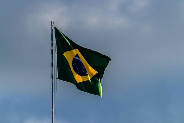 istock Brazilian flag waving against a blue sky 2215984945