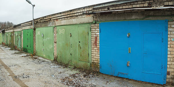 old combined garages in rural areas, closed garage doors in cloudy autumn weather
