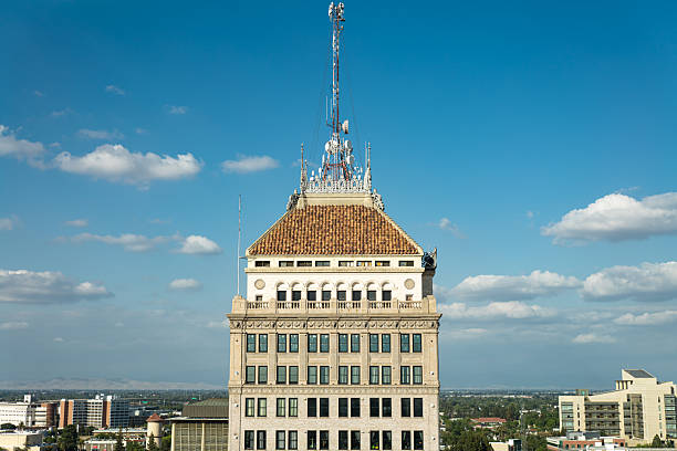 Aerial shot of downtown Fresno, California on a sunny day in spring, looking up at the antennae on the roof of the historic Pacific Southwest Building.