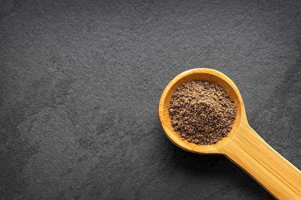 Piper nigrum - Aromatic black pepper on a spoon
