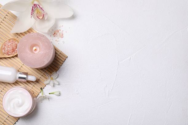 istock Beautiful spa composition with cosmetic products and flowers on white table, flat lay. Space for text 2215996353