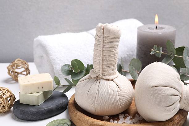 istock Spa composition with herbal massage bags and eucalyptus branches on white table 2215996354