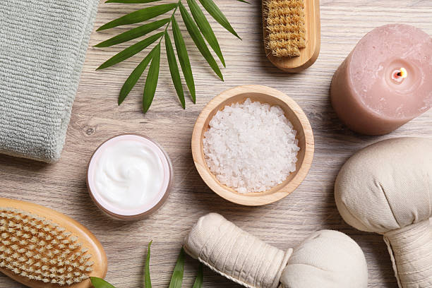 istock Flat lay composition with spa products and burning candle on light wooden table 2215996436