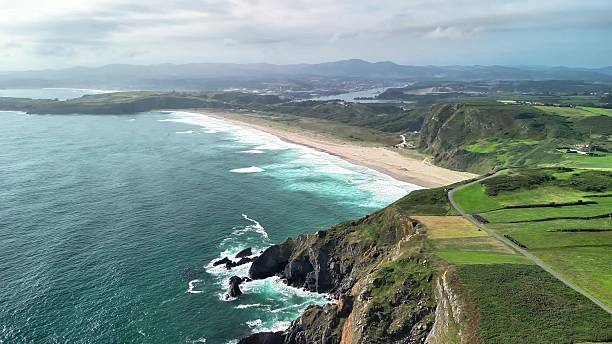 istock The breathtaking coastal landscape features dramatic cliffs alongside a beautiful sandy beach 2215998978