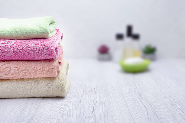 istock Clean towel, shampoo, conditioner, and soap arranged on a soft background, perfect for adding promotional content. 2216001687