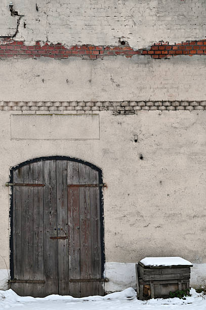 istock Locked wooden door in old brick wall 2216004831