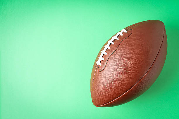 istock American football ball on mint background, space for text 2216005330