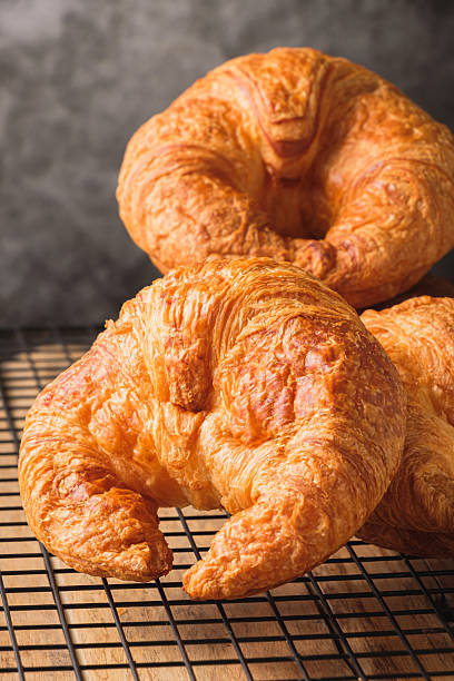 istock Three Croissants Stacked on a Wire Rack, Cooling Rack. 2216008122