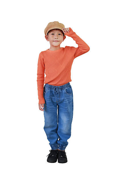 istock Smiling Asian boy child wearing brown cap hat with holding hat and making staring posture looking straight at camera isolated on white. Image full length with clipping path. 2216009379