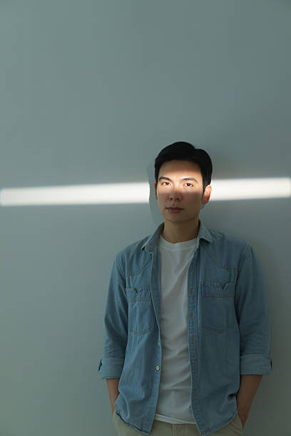 istock Portrait of a Stylish Young Man with Artistic Lighting Effect 2216013937