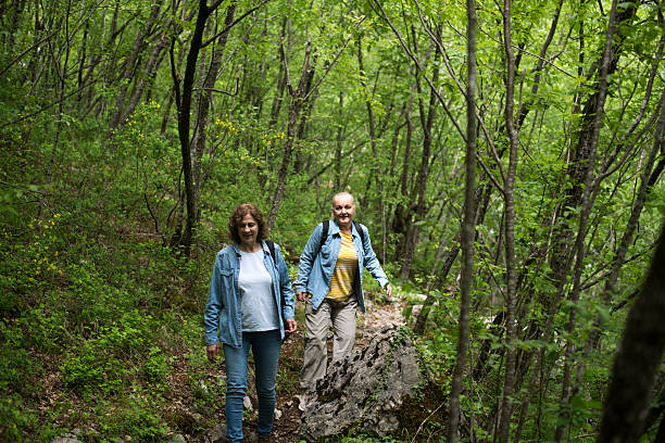 istock Women travellers hiking down forest trail on summer day 2216015177