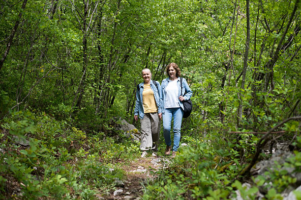 istock Women travellers hiking down forest trail on summer day 2216015327