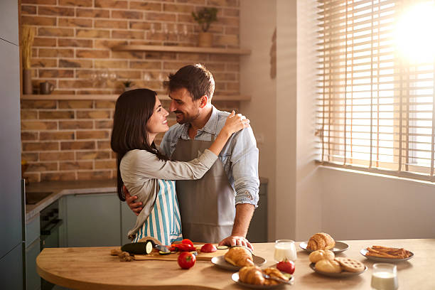 istock Young happy couple in love talking in the kitchen. 2216016163