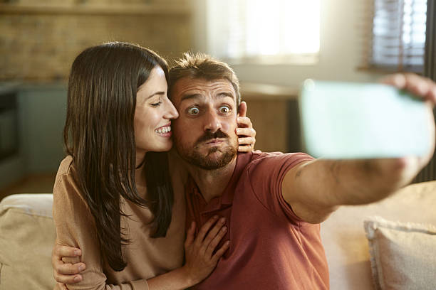 istock Happy couple taking a selfie with cell phone at home. 2216016535