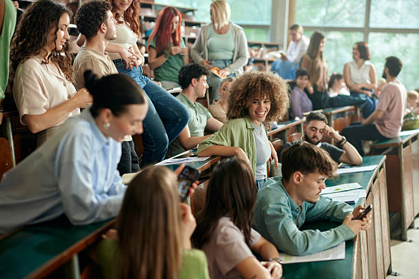 istock Happy college students talking on a break in amphitheater. 2216018498