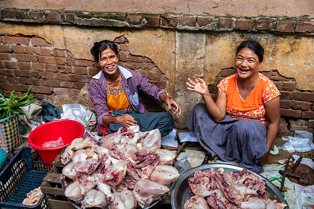 Burmese women selling raw meat on a local market in Bagan, Myanmar