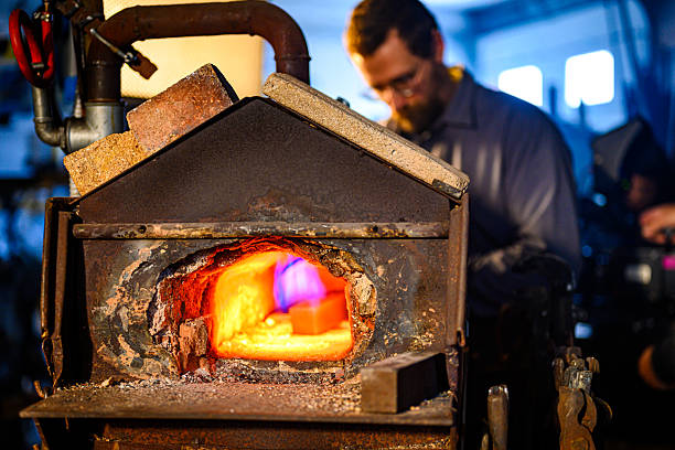 A mid adult Caucasian male blacksmith works in a rustic workshop, heating a metal piece in a glowing forge. The warm, fiery light contrasts with the cool, industrial background, creating a dynamic atmosphere.