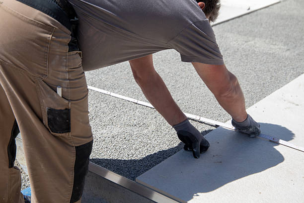 istock Craftsmen lay terrace slabs on a new building 2216022128