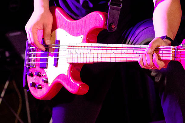 Mid adukt man plays electric guitar