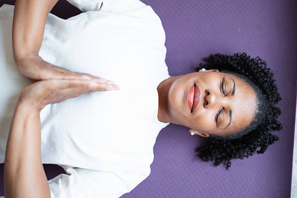istock Woman Practicing Yoga and Relaxation Techniques on a Yoga Mat 2216024286
