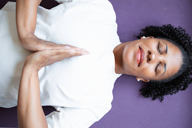 istock Relaxed woman lying on her back practicing yoga meditation indoors 2216024302