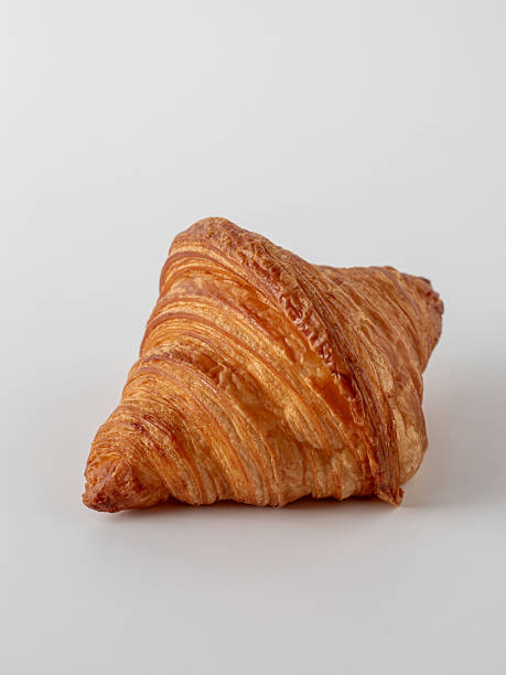 istock Golden Croissant on White Background Perfect for Breakfast and Snacks 2216025701