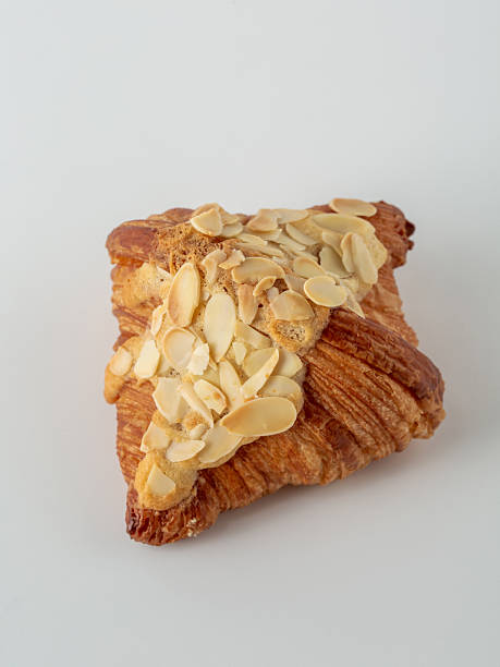 istock Flaky Almond Croissant Pastry on Plain White Background 2216025712