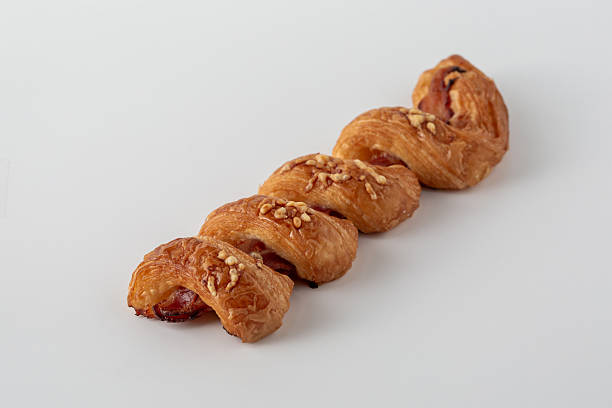 istock Flaky Pastry Roll with Sweet Filling and Nuts on White Background 2216025742