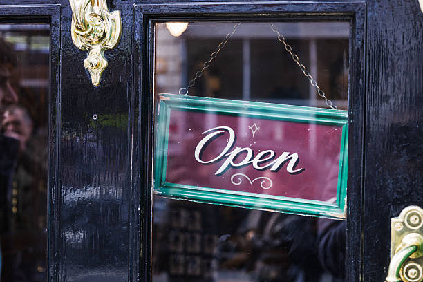 istock Open Sign Displayed in Window of Black Storefront Inviting Customers Inside 2216026565