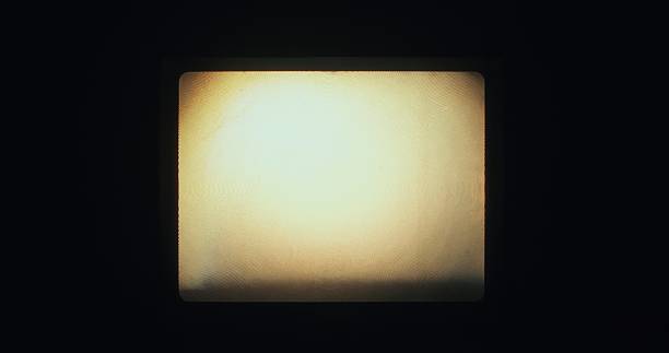 istock A blank frame glows on screen during backstage 16mm film projection from analog equipment. 2216026630