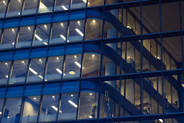 istock Modern Office Building with Illuminated Windows at Night in Urban Business District 2216026716
