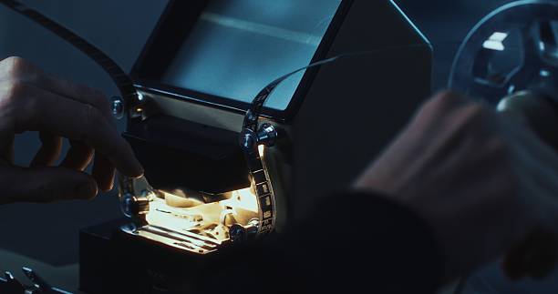 istock A backstage look at a director threading 16mm film through an analog editing table. 2216026907