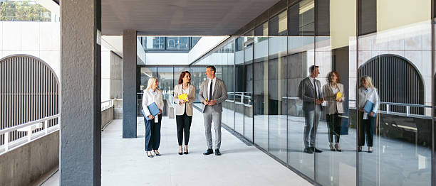istock Business team discussing contract terms outside modern office building 2216029758