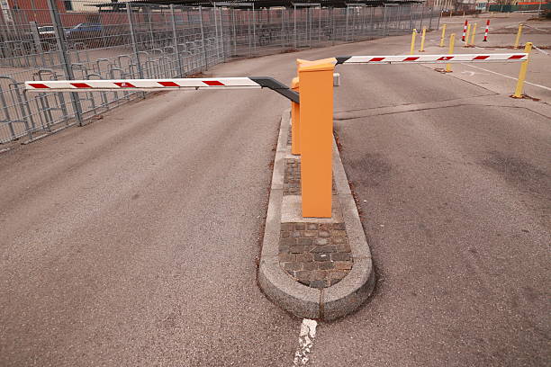 istock Yellow and orange traffic barrier with red and white stripes 2216031400