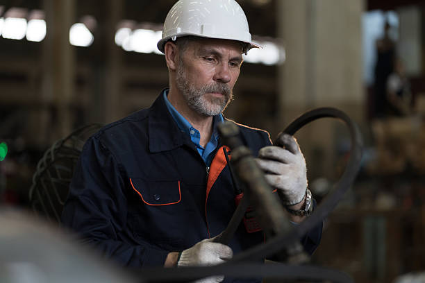 istock Worker, engineer, factory or storage warehouse. Senior engineer working in industry factory, inspection of machine for manufacturing, maintain, repair in industry warehouse 2216033096