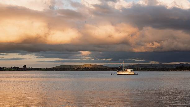 istock Boat on calm waters at sunset 2216033126