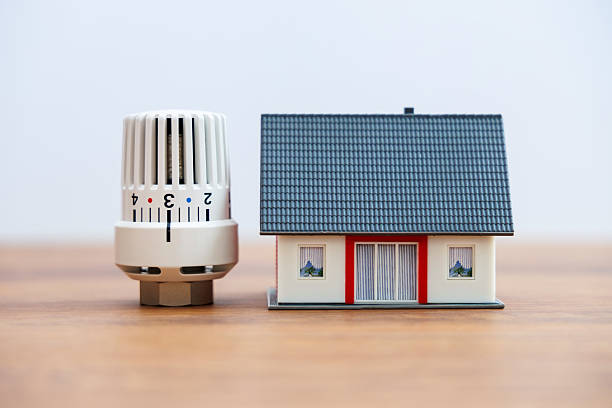 House model stands next to a radiator thermostat