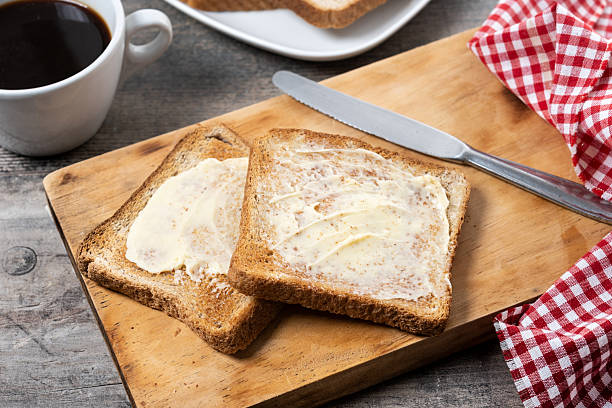 istock Sliced fresh bread and butter on wooden table 2216034089