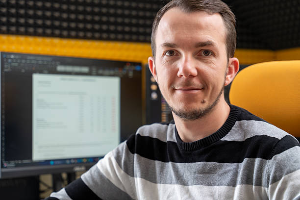 istock Smiling man in home office workspace sitting at desk with document displayed on screen, reflecting satisfaction or successful work 2216035395